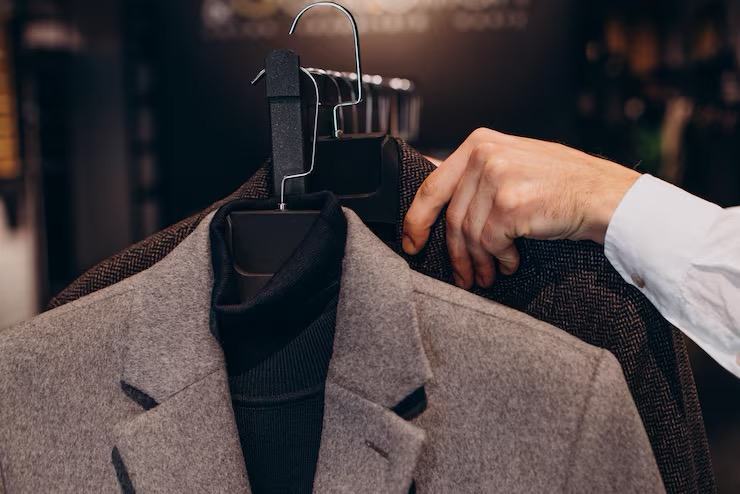 Premium dry cleaning and garment care at Cleanofy — men's coat freshly pressed on hanger